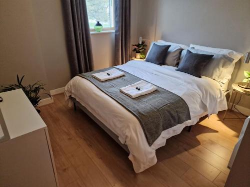 a bedroom with a large bed with two towels on it at Halton Hideaway in Halton