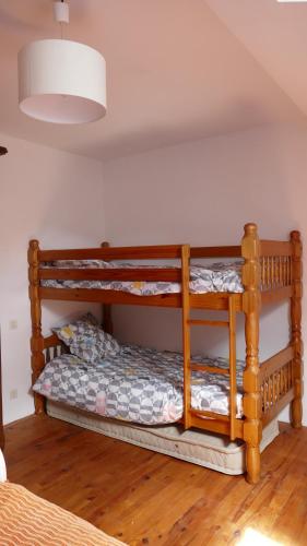 a bedroom with two bunk beds in a room at "La Résistance" proche du Pal in Loddes