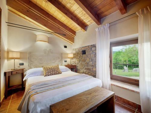 a bedroom with a large bed and a window at Tenuta Valdea in Firenzuola