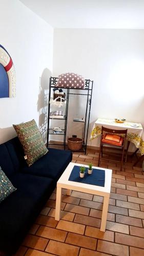 a living room with a couch and a table at Lighthouse Taranto in Taranto