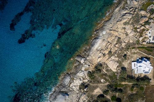 an aerial view of a house on the shore of the ocean at Acron Vigla in Mikri Vigla