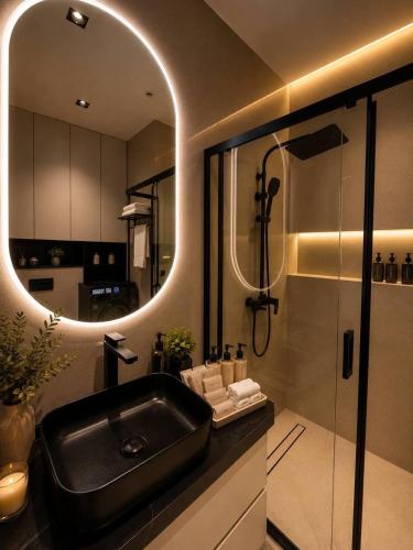 a bathroom with a black sink and a shower at AsiaWay Apartment-NEST ONE in Tashkent