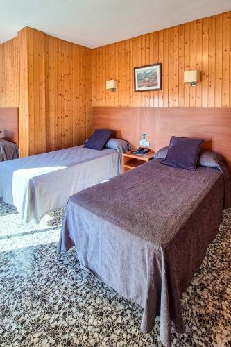 Llit o llits en una habitació de Hotel Jardín