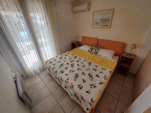 a small bedroom with a bed with an orange headboard at Villa Lemóni - Villa by the sea with swimming pool and amazing view in Xiropigado
