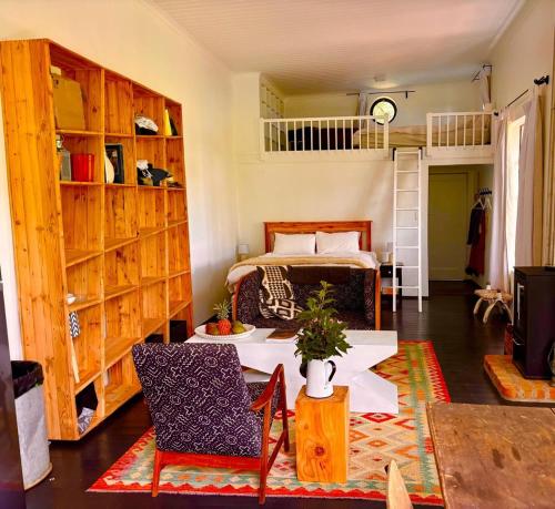 a room with a bed and a table and chairs at Field Cabin in Rosendal