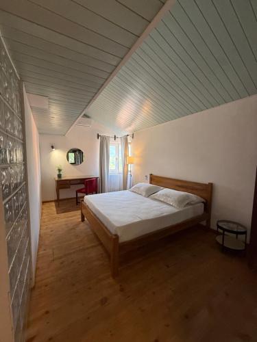 a bedroom with a large bed in a attic at Laurus Home Restaurant B&B Cilento in Trentinara
