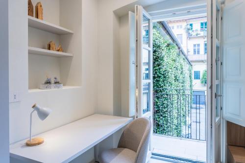 a home office with a desk and a window at Civico Due in Cuneo