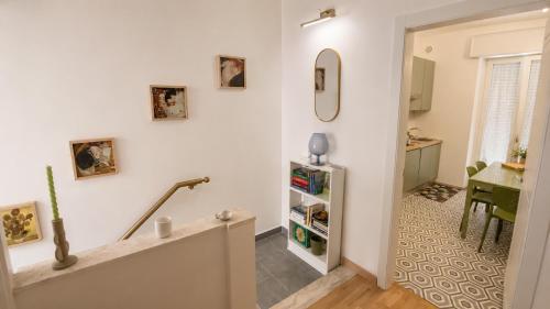 a living room with a staircase and a table at Zia Piera in Follonica