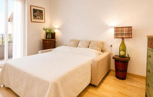 a bedroom with a white bed and a window at Zia Piera in Follonica