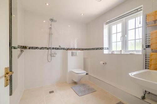 a white bathroom with a toilet and a sink at 1 Bed in Taunton oc-75135 in Isle Brewers