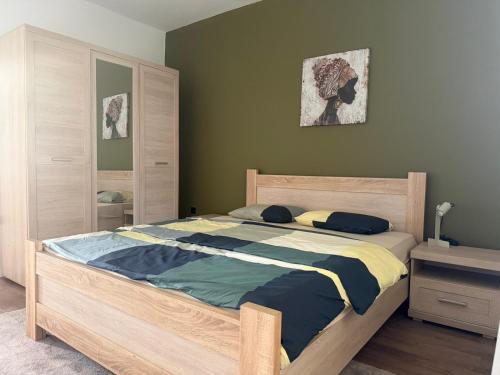 a bedroom with a large bed with a wooden frame at Casa nel verde in Bar