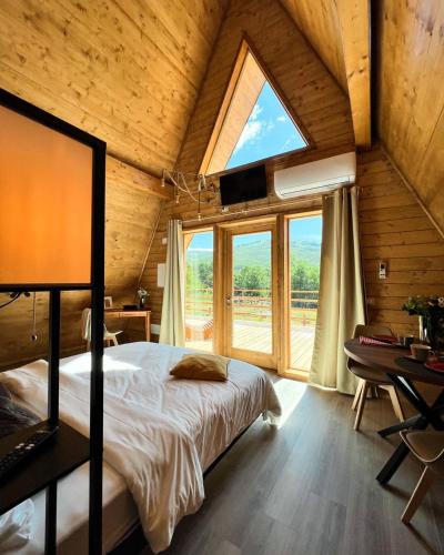 a bedroom with a bed and a large window at Guarda Che Luna in Sasso di Castalda