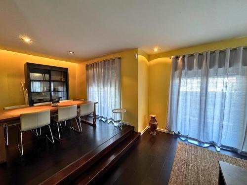 a dining room with a table and chairs at Cascais House - Pool in Parede