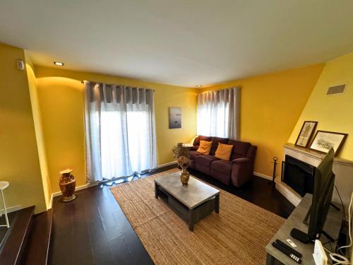 a living room with a couch and a table at Cascais House - Pool in Parede
