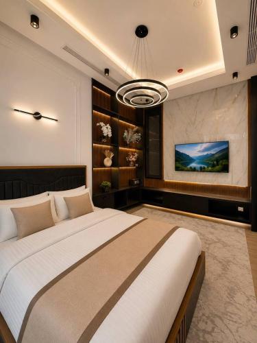 a bedroom with a large bed and a flat screen tv at AsiaWay Apartment-NEST ONE in Tashkent