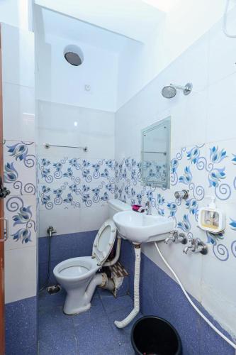 a bathroom with a toilet and a sink at Silver residency in Bhubaneshwar