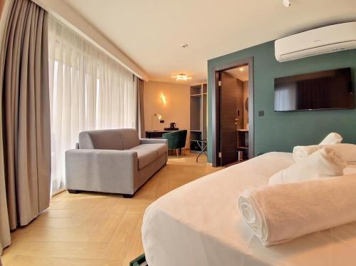 a hotel room with two beds and a living room at A Plus Hotel St Julians - Adults Only in St. Julianʼs