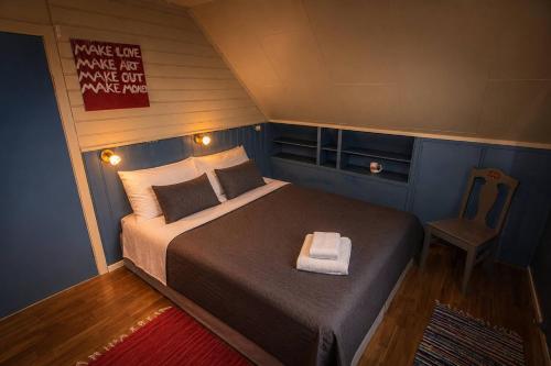 a small bedroom with a bed and a chair at Charming Casa Hauge BB Sunset Room in Sandane