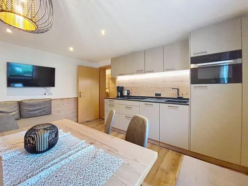 a kitchen with a table and a dining room at Apartment Neuner-1 by Interhome in Hippach