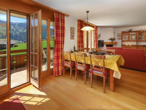 a dining room with a table and a couch at Apartment Chalet Nagano by Interhome in Grindelwald
