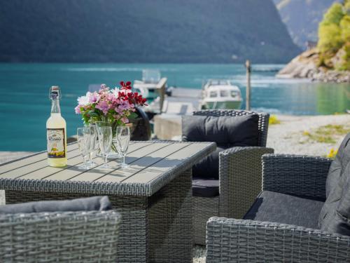 a table with a bottle of wine and flowers on it at Apartment Vardeheii by Interhome in Arnefjord