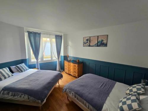 a bedroom with two beds and a window at Au Petit Crecy in Crécy-la-Chapelle