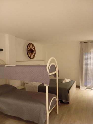a bedroom with a bed and a clock on the wall at Sabry holiday Terrasini in Terrasini
