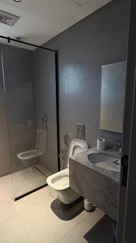 a bathroom with a sink and a toilet and a shower at KL Studios in Al Khobar