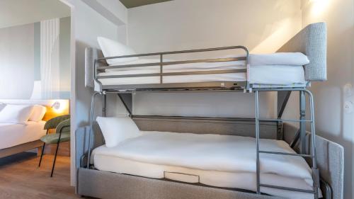 a bunk bed in a room with a bunk bedutenewayangering at Kyriad - Royan Plage in Royan