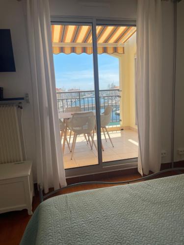 a bedroom with a bed and a view of a balcony at loft appartement in Cap d'Agde