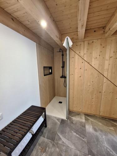 a room with a bed and wooden walls at Villa Barbosa in Quintiães
