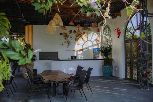a dining room with a table and chairs and stained glass windows at Nhat Quang Hotel in Bảo Lộc