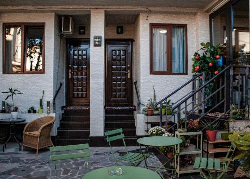 a house with tables and chairs in front of it at Old Tbilisi in Itʼkhvisi