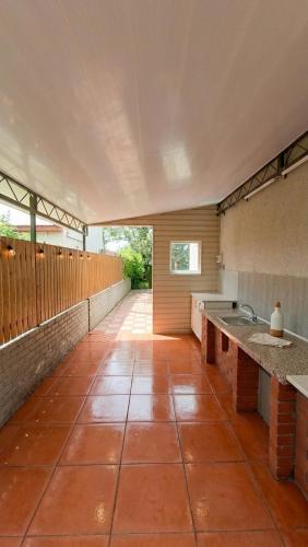 a large kitchen with a tile floor and a sink at У Олексія in Karolino-Buhaz