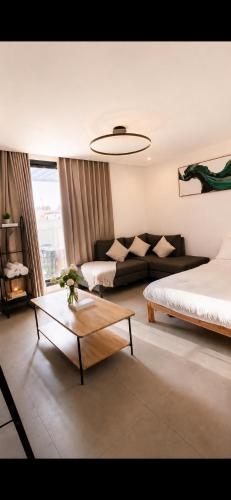 a living room with a bed and a couch at KL Studios in Al Khobar