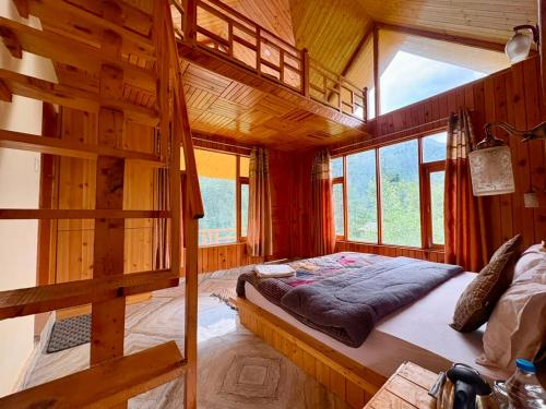 a bedroom with a bunk bed in a wooden cabin at Flamingo Aur Maina Stays - Jibhi in Jibhi