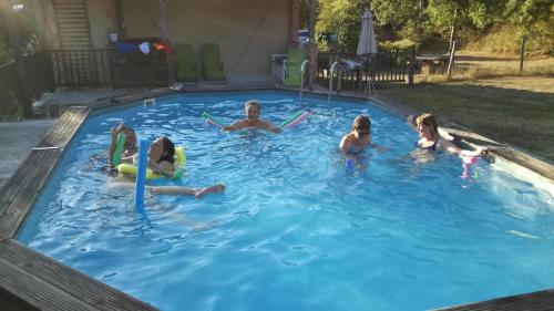 a group of people playing in a swimming pool at Grésigne in Larroque