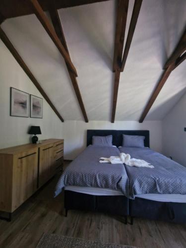 a bedroom with a bed with two towels on it at Vacation Home Belluna in Račić