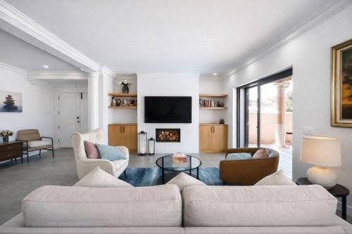 a living room with two couches and a fireplace at Solstice Villa Private Pool & BBQ Cascais in Alcabideche