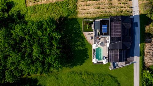 an overhead view of a house with solar panels on a field at Northern Croatia Accessible Luxury Villa in Cestica