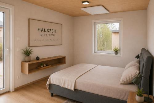 a bedroom with a bed and two windows at Hauszeit mit Pfoten in Litschau