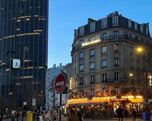 a building on a city street with people walking around at Hôtel Odessa Montparnasse in Paris