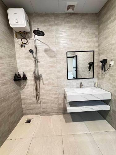 a bathroom with a sink and a mirror at Cactus Hotel in Dar es Salaam