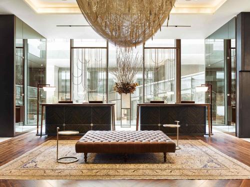 a lobby with a bench in the middle of a room at Fairmont Quasar Istanbul Hotel in Istanbul