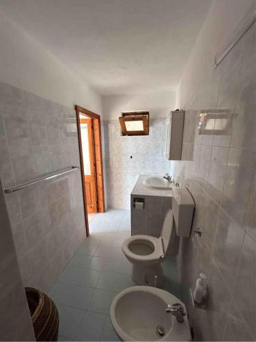 a bathroom with a toilet and a sink at Melania Home in Filicudi