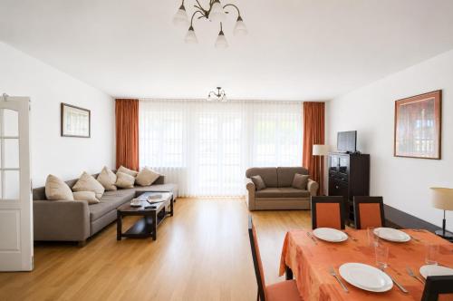 a living room with a couch and a table at Extra Apartamenty - Apartament przy plaży in Sopot