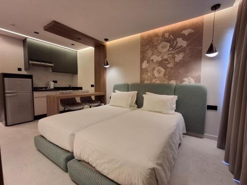 a hotel room with two beds and a kitchen at Résidence Hotelière Fleurie in Agadir