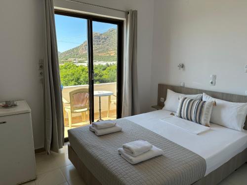 a bedroom with a bed with two towels on it at Aqua Marine in Falasarna