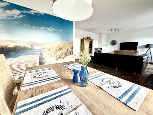 a living room with a beach mural on the wall at Ferienwohnung Achterbrise mit Kamin in Zinnowitz