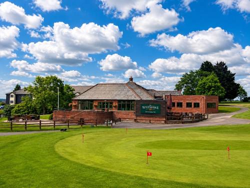 a building with a green field in front of it at The Wiltshire Hotel, Golf and Leisure Resort in Swindon